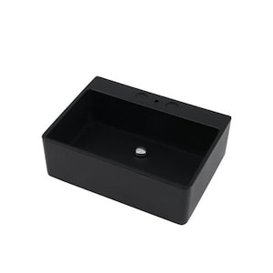 May include: A rectangular, matte black bathroom sink with a drain and faucet holes. The sink has a simple, modern design and is set against a white background. The sink's interior is a deep black, contrasting with the exterior.