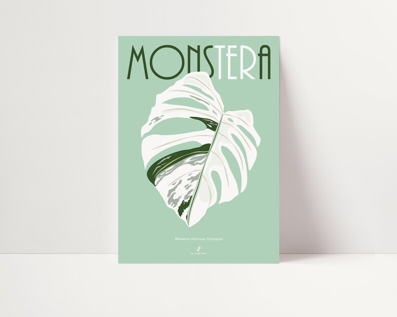 May include: A poster with a green background featuring a white Monstera Deliciosa Variegata leaf with green veins. The text "Monstera" is in a bold, black font at the top of the poster.