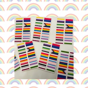 May include: A set of six colorful stickers featuring different variations of the progress pride flag. Each sticker has a white background and is printed with a variety of colors, including red, orange, yellow, green, blue, indigo, and violet. The stickers are perfect for adding a touch of pride to laptops, water bottles, or other surfaces.