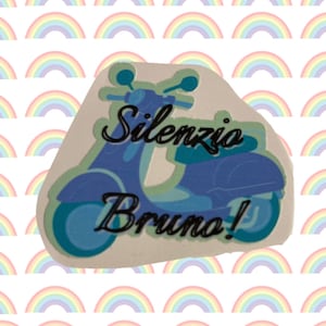 May include: A white sticker with a blue and green scooter illustration. The scooter has the words "Silenzio Bruno!" written on it.