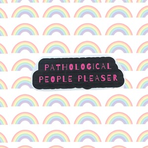 May include: A black and white sticker with the text "Pathological People Pleaser" in pink letters on a white background with a rainbow pattern.