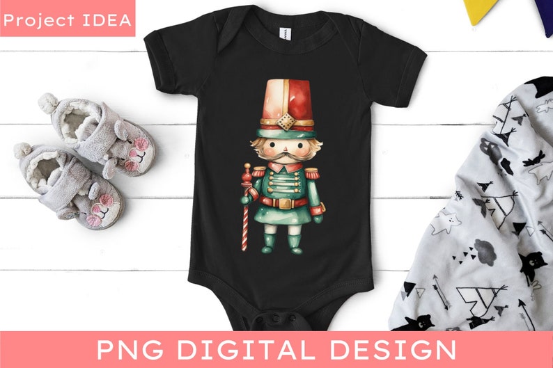 May include: A black baby onesie with a watercolor illustration of a toy soldier. The soldier is wearing a red and white hat, a green uniform, and holding a candy cane.