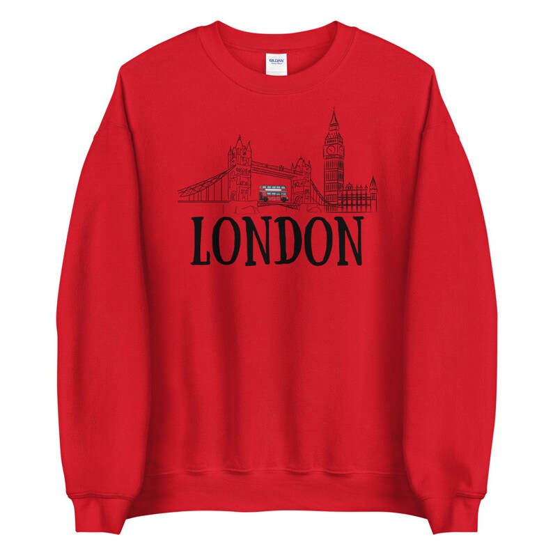 May include: Red sweatshirt with a black outline of the London skyline, including Big Ben and Tower Bridge, and the word "LONDON" in black text.