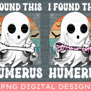 May include: A digital design featuring two cartoon ghosts holding bones. The ghosts are white with black eyes and mouths. The bones are white and pink with a leopard print. The background is a retro sunset with a spiderweb pattern. The text "I found this humerus" is written in white letters on a gray background.