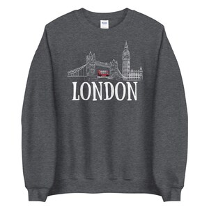 May include: A dark grey sweatshirt with a white outline of the London skyline, including Big Ben and Tower Bridge, and the word "LONDON" in white text.