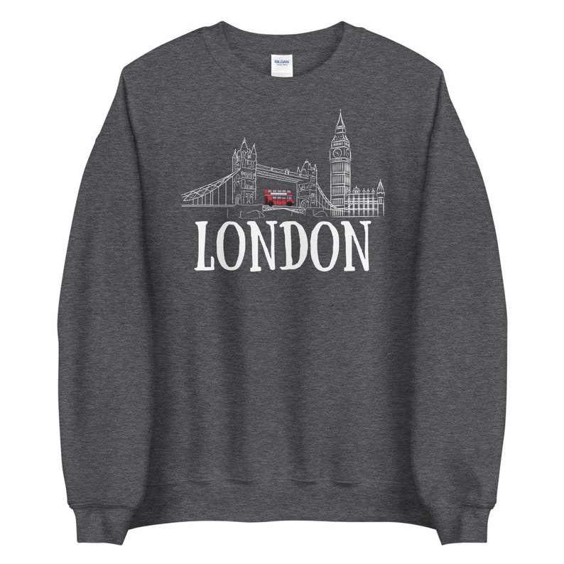 May include: A dark grey sweatshirt with a white outline of the London skyline, including Big Ben and Tower Bridge, and the word "LONDON" in white text.