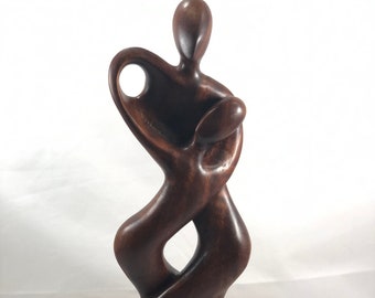 The Dancers. 15.5” tall  woooden abstract sculpture.  Hand carved. Natural finish.  2 choices. Tango or Boogie.  Graceful lines.