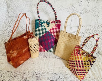 Handwoven palm leaves party favor, utility bags. Coconut coir bags.  Dried, hand dyed and woven. With handle.  Varied sizes 10”-5.5” tall.