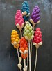 Corn Husk Flowers. Handmade Using Dyed Dried Corn Husks. Bamboo Stems Wrapped in Dried Banana Bark.  20” Long. Flower size varies about 6”. 