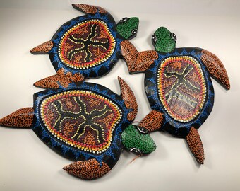 Three gorgeous wooden turtles in a merry-go-round.  Handcarved, handcrafted wall hanging. Intricately hand-painted with dot art.