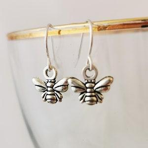 Tiny dangly bumble bee earrings. Silver plated, nickel free, hypoallergenic