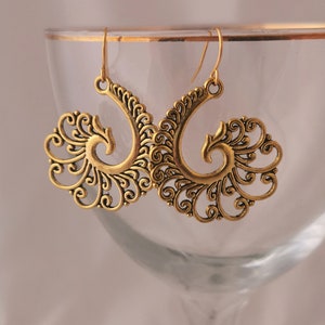 Gold boho peacock feather swirl earrings