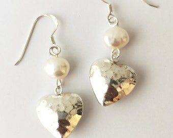 Hammered heart and freshwater pearl dangly earrings on sterling silver hooks