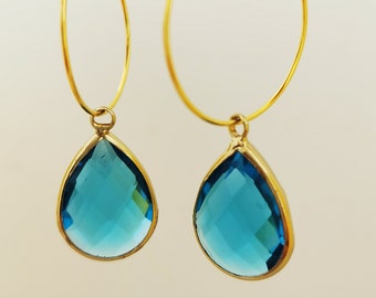 Gold hoop earrings with faceted glass drops