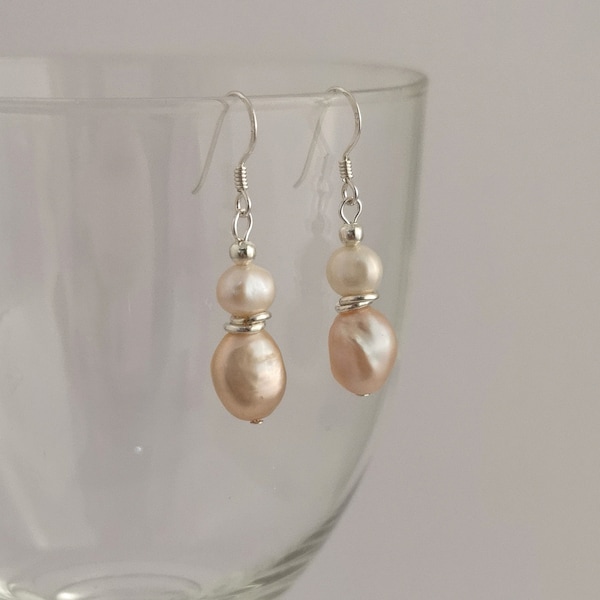 Pink and white freshwater pearl drop earrings on sterling silver hooks. Peach pink baroque pearl earrings