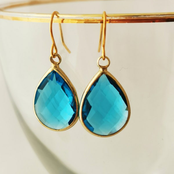 Bright blue faceted glass teardrop shape earrings. Gold plated, nickel free, hypoallergenic