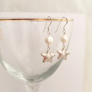 Silver star and freshwater pearl dangly earrings on sterling silver hooks