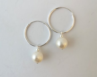 Sterling silver pearl hoop earrings.