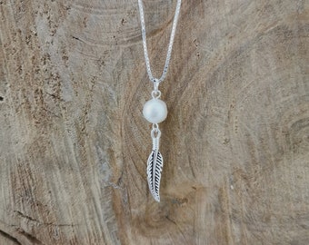 Sterling silver feather and freshwater pearl pendant necklace.