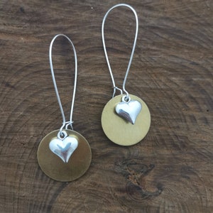 Large gold and silver heart earrings. Dangly silver and gold earrings.