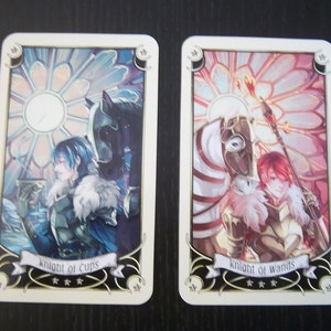 May include: Two tarot cards, Knight of Cups and Knight of Wands, with colorful illustrations of knights on horseback. The Knight of Cups card features a blue knight holding a cup, while the Knight of Wands card features a red knight holding a staff.