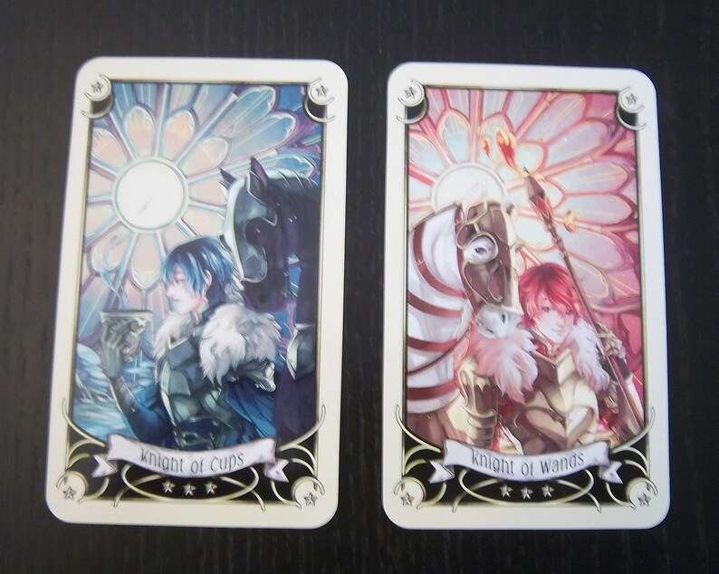 May include: Two tarot cards, Knight of Cups and Knight of Wands, with colorful illustrations of knights on horseback. The Knight of Cups card features a blue knight holding a cup, while the Knight of Wands card features a red knight holding a staff.