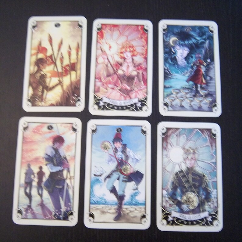 May include: Six tarot cards with illustrations of people and symbols. The cards are in a white frame with gold accents. The cards are numbered 1 through 6. The cards are from a tarot deck called "The Enchanted Tarot".