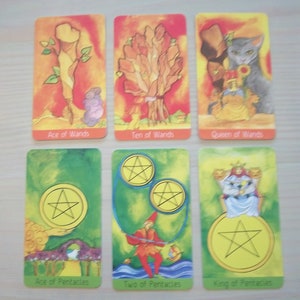 May include: Tarot card deck featuring colorful illustrations of the Ace of Wands, Ten of Wands, Queen of Wands, Ace of Pentacles, Two of Pentacles, and King of Pentacles.