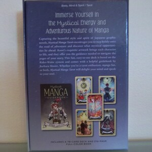 May include: A purple box with a tarot deck titled "Mystical Manga Guidebook" featuring a 78-card deck and a 216-page full-color book. The box shows images of the cards with colorful illustrations of characters and scenes.