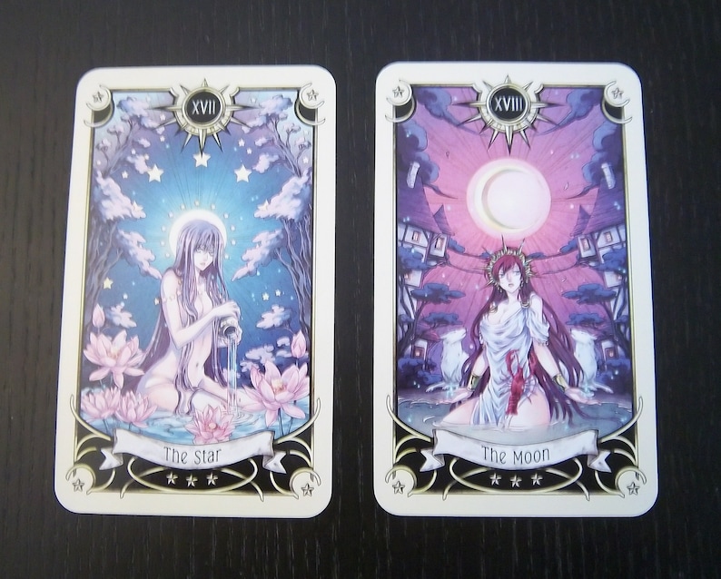 May include: Two tarot cards, The Star and The Moon, with illustrations of women in a celestial setting. The Star card features a woman pouring water from a pitcher into a pool of water with lotus flowers. The Moon card features a woman standing in a body of water with a crescent moon in the sky. Both cards have a gold border and the Roman numeral XVII.