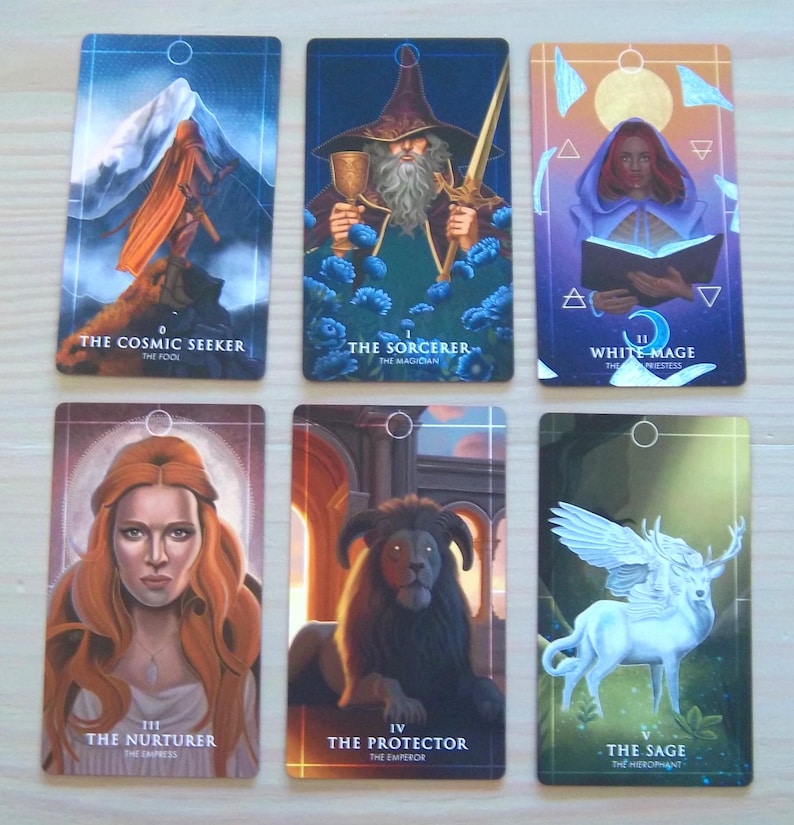 May include: Set of ten tarot cards with colourful illustrations and gold accents. The cards feature images of a cosmic seeker, a sorcerer, a white mage, a nurturer, a protector, a sage, a lover, a chariot, a strength, and a hermit.