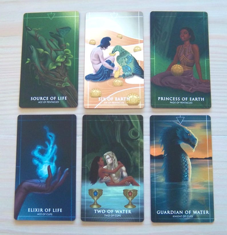 May include: Tarot card deck featuring illustrations of various elements, including a hand holding a green plant, a person feeding a bird, a woman sitting on a throne, a hand holding a blue flame, two people embracing, and a sea serpent. The cards are labelled with the names of the suits and the card number.