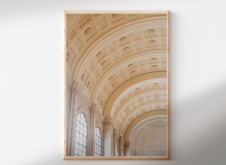 May include: A photograph of a grand, ornate interior with a high vaulted ceiling. The ceiling is made of white plaster and features intricate patterns of arches and moldings. The walls are also white and have large windows that let in natural light. The overall effect is one of grandeur and elegance.
