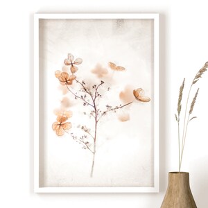May include: A framed print of a delicate, dried flower arrangement in shades of brown and beige. The flowers are arranged on a white background with a subtle texture.