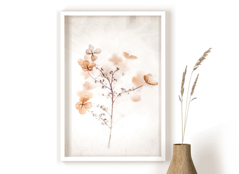 May include: A framed print of a delicate, dried flower arrangement in shades of brown and beige. The flowers are arranged on a white background with a subtle texture.