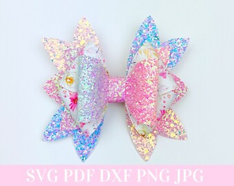 May include: A multi-layered iridescent glitter bow with a floral print center. The bow has a pointed shape and is made of multiple layers of glitter fabric.
