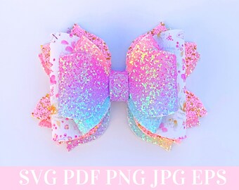 May include: A pink, blue, and white layered glitter bow with a floral pattern. The bow is made of fabric and has a shimmery finish.