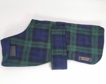 May include: A green and blue plaid fleece dog coat with a velcro closure and a "Posh Paws Boutique" label.