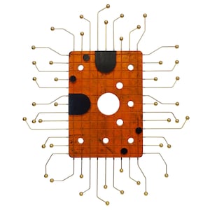 May include: An orange circuit board with black accents and gold wires extending from the sides. The board has a circular hole in the center and a grid pattern.
