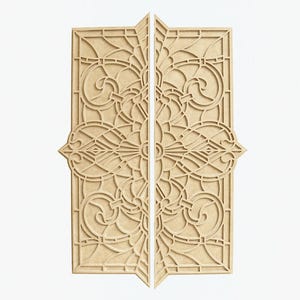 May include: Two wooden panels with intricate cut-out designs, resembling stained glass windows. The panels are light brown and have a symmetrical pattern of swirls and lines.