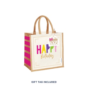 May include: A reusable jute tote bag with pink and gold stripes. The bag has a white front with the words "Happy Birthday" in colorful letters and a pink bow.