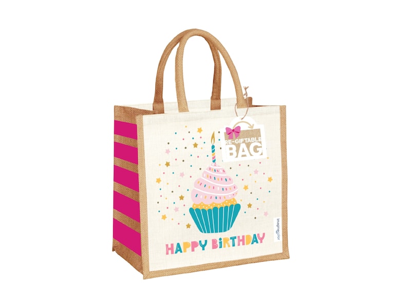 May include: A pink and white cupcake with a lit candle on top, surrounded by gold stars, on a beige and pink striped reusable gift bag with the text "Happy Birthday" and "Re-Giftable Bag".