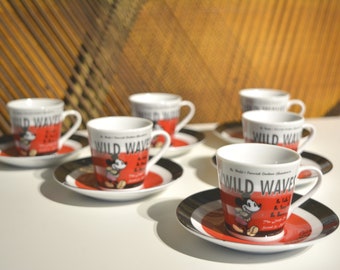 May include: Set of six white ceramic teacups and saucers with a red and black design featuring Mickey Mouse and the text "Wild Waves".