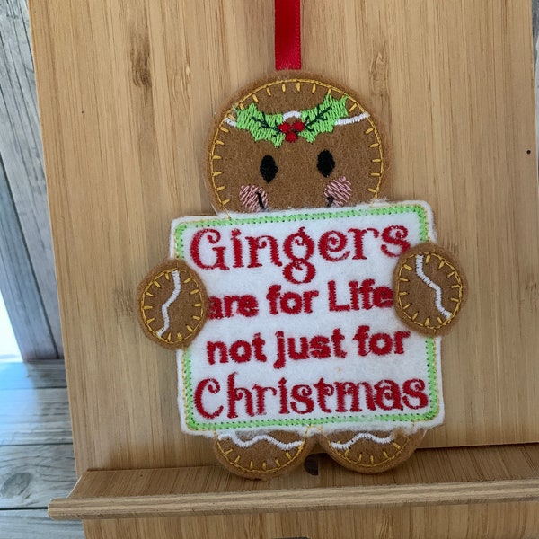 Gingerbread man holding "Gingers are for Life" board