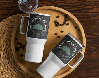 May include: Two white travel mugs with black and green logos that say "Corey Davis Woodcrafts" and "Since 2020". The mugs are on a wooden tray with coffee beans.
