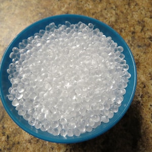 May include: A blue bowl filled with clear, translucent packing peanuts.