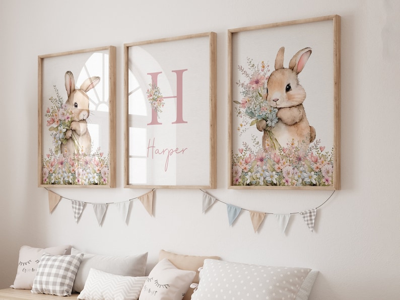 May include: Three framed prints featuring a watercolour illustration of a bunny holding flowers. The middle print has the letter "H" and the name "Harper" in pink script.