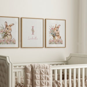 May include: Three framed prints featuring a watercolour illustration of a bunny holding flowers. The middle print has the letter "I" and the name "Isabella" written below it.