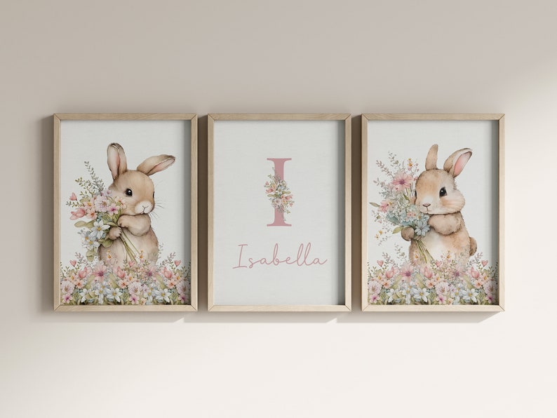 May include: Three framed prints featuring a watercolour illustration of a bunny holding flowers. The middle print has the letter I and the name Isabella.
