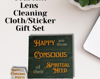 Puede incluir: Un juego de regalo que incluye un paño de limpieza de lentes y una pegatina. El paño verde oscuro tiene texto dorado que dice: "HAPPY are those CONSCIOUS of their SPIRITUAL NEED." La pegatina tiene el mismo texto. El juego está etiquetado como "Yeartext Lens Cleaning Cloth/Sticker Gift Set."